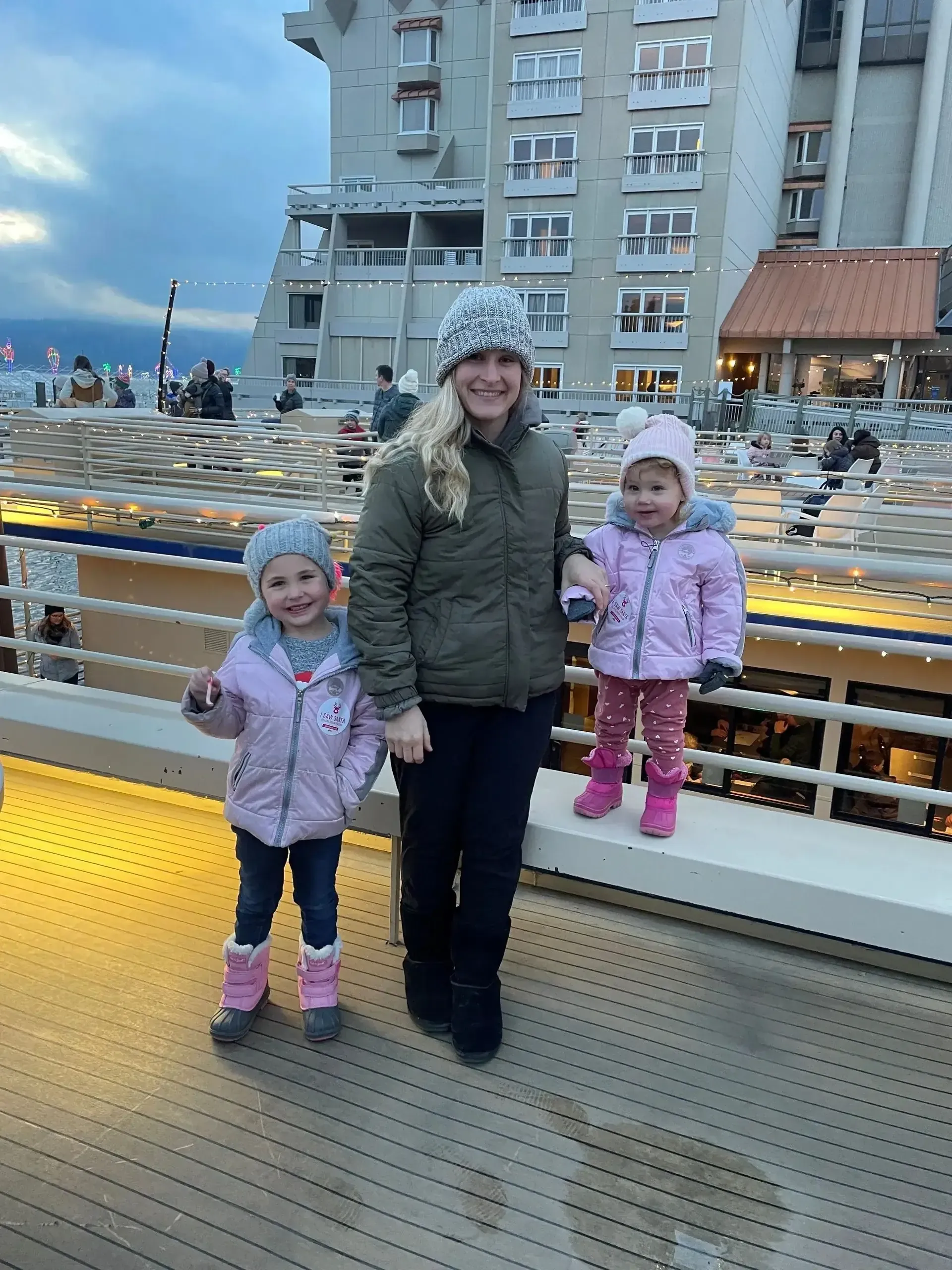 Amy with her husband and two daughters outdoors
