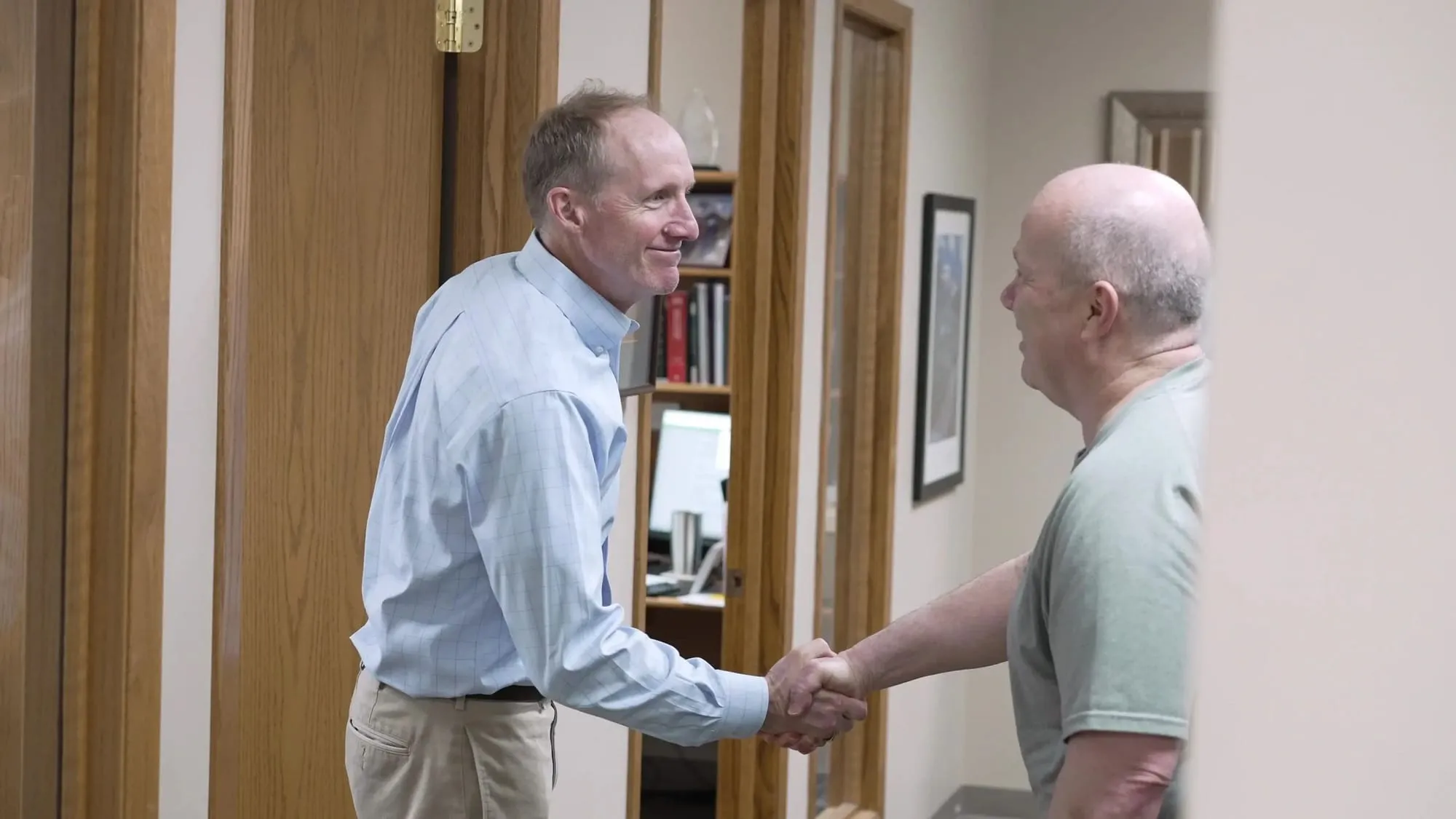 Financial advisor welcoming a new client with a handshake