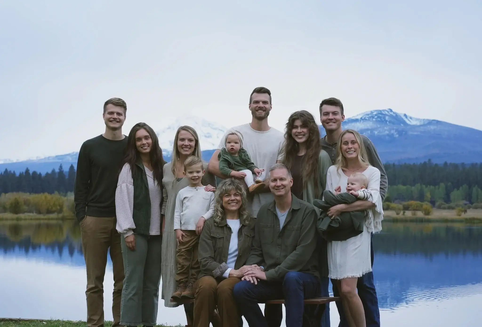 Noah’s family at a Spokane-area lake with snowy mountains