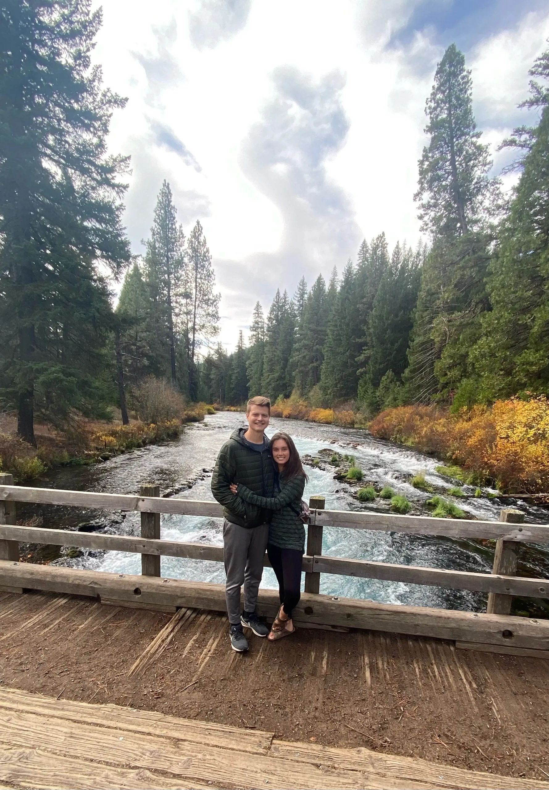 Noah and Jenny on a bridge over a Pacific Northwest creek